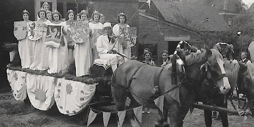De dames dragen schilden met daarop afgebeeld de provinciewapens
